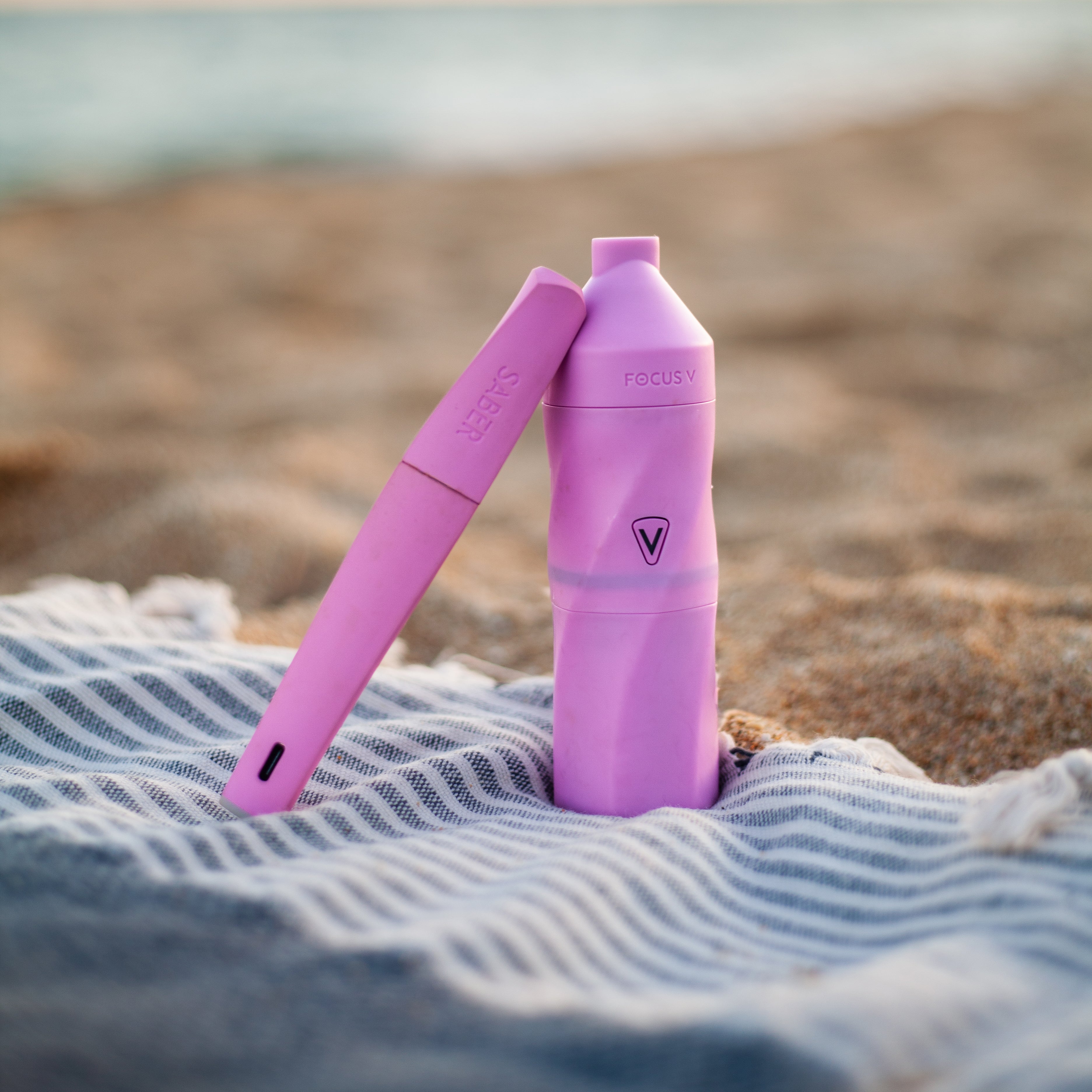 Lifestyle photography of a Focus V AERIS electric dab rig paired with the SABER electric dab tool, showing a compact electric rig setup designed for flexible, on-the-go sessions